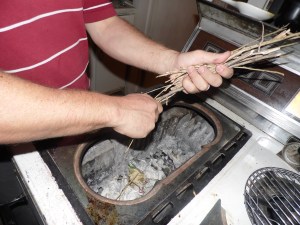 Place smaller twigs, leaves, pine needles across newspaper.