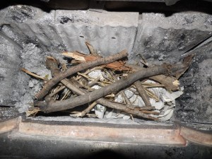 Small branches are crisscrossed across the kindling.