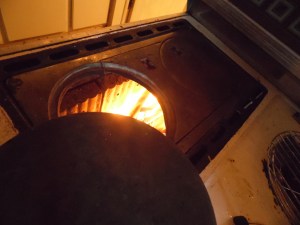 After the kindling catches, add small pieces of wood, then a larger log.  Blow into the fire to make it catch more.  Once the log has caught, close the flue.