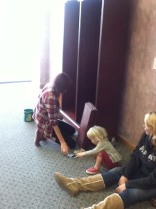 Emily, Maryjane, and their friend, Becca put together shelving.